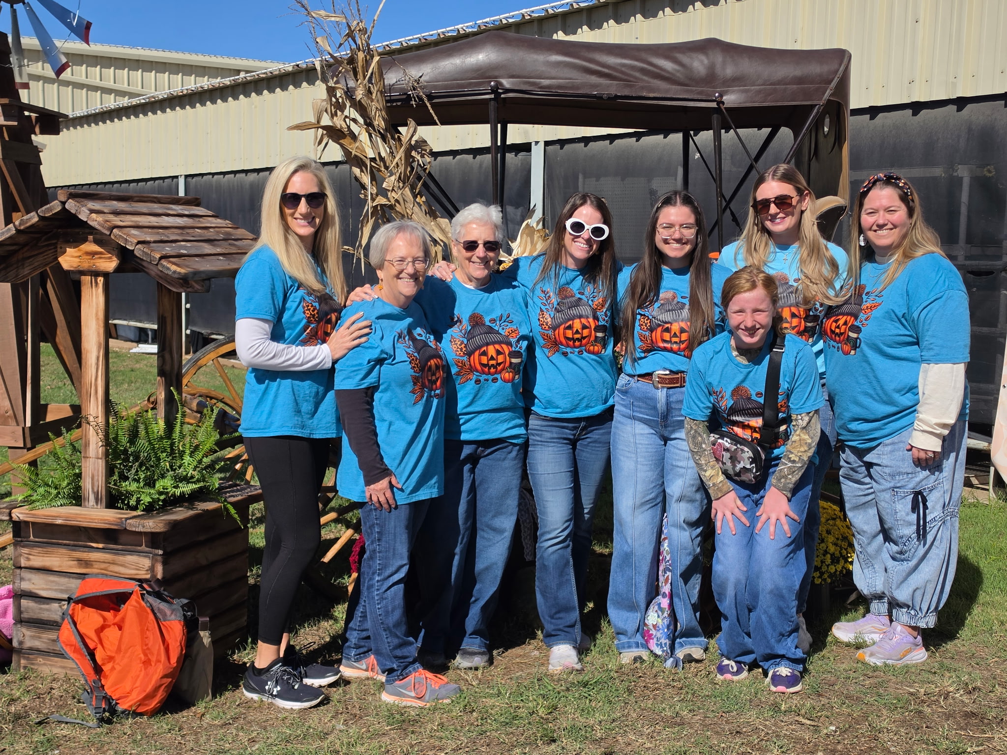 The author smiling outdoors with a group of female family members, all standing close together and posing for a photo during their annual girls’ trip.